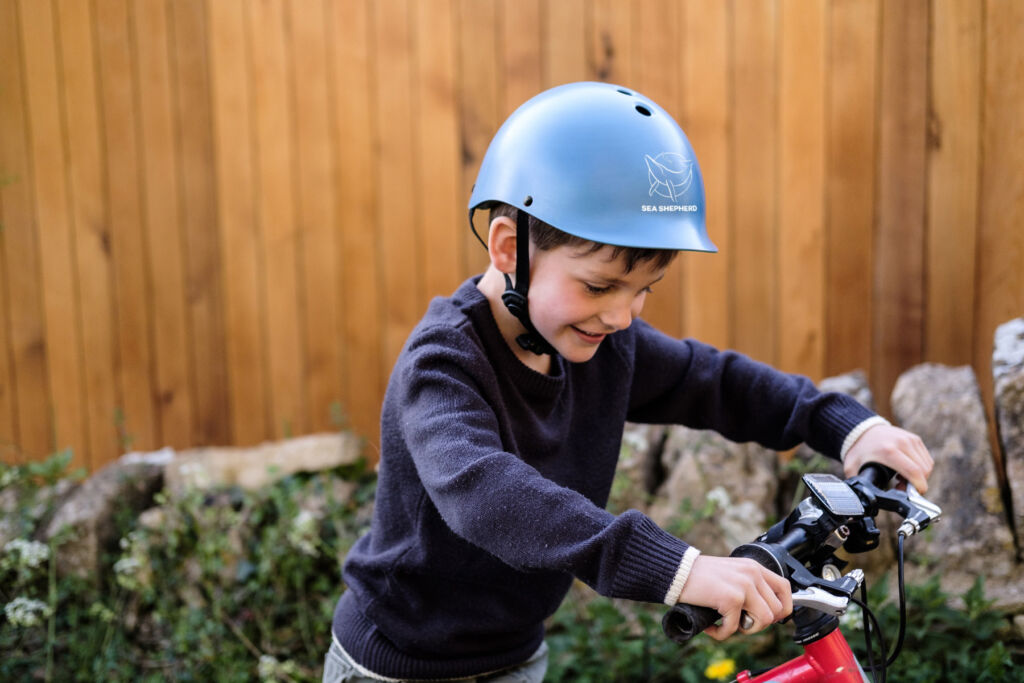 A young boy wearing the blue coloured helmet