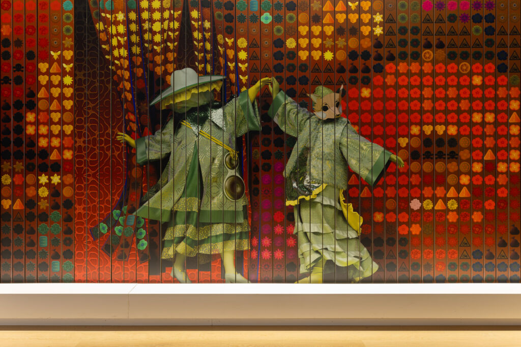 Two animal figures dancing on the panel