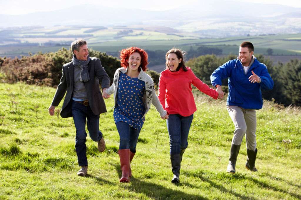 A group of four friends walking in the countryside