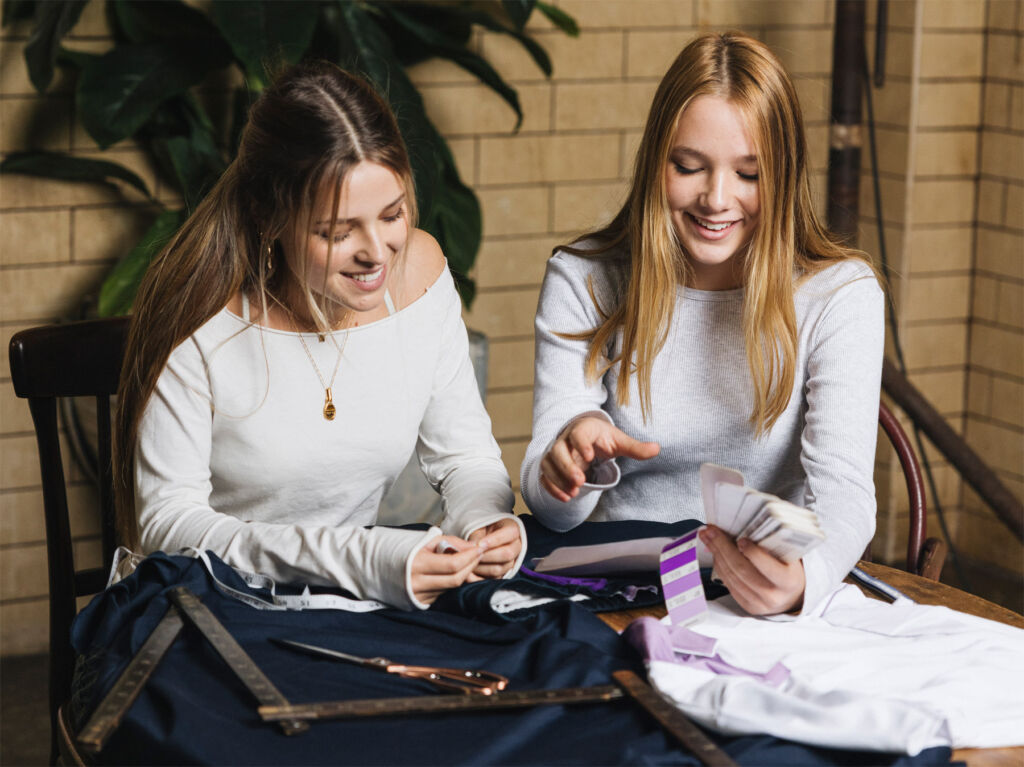 The sisters at their design table