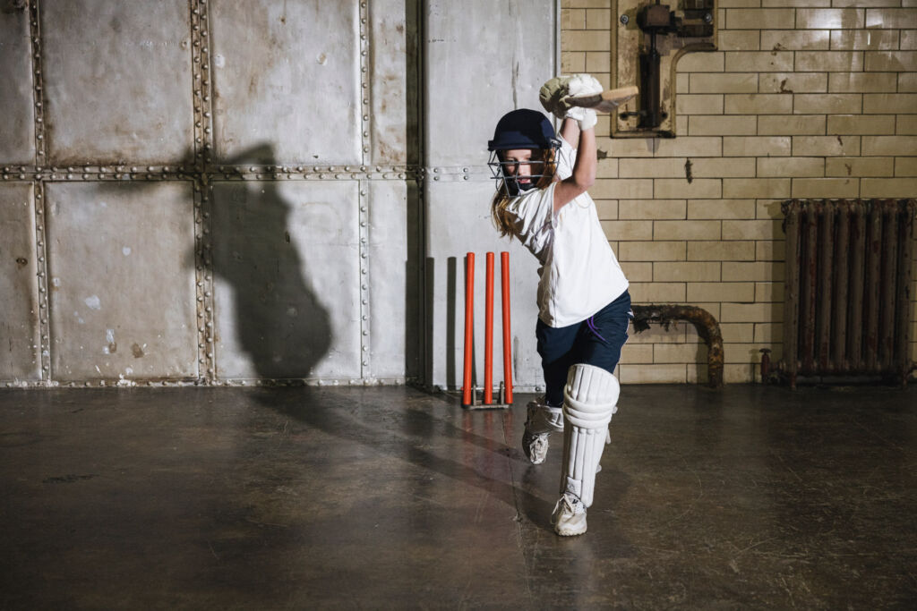 One of the sisters showing perfect cricket form while playing a shot