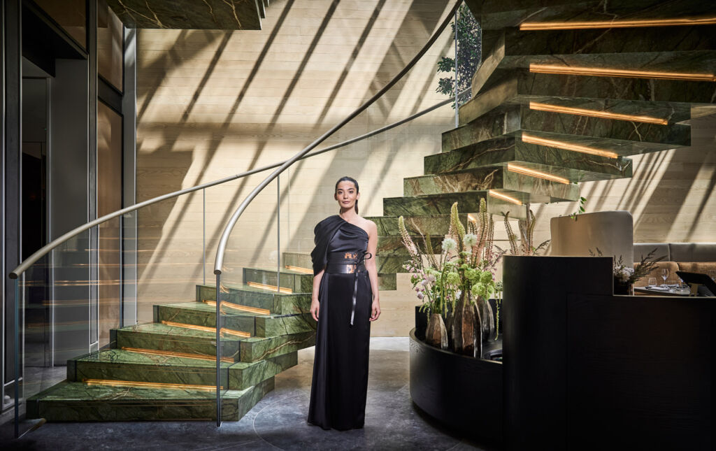 A female member of staff wearing a classic black gown