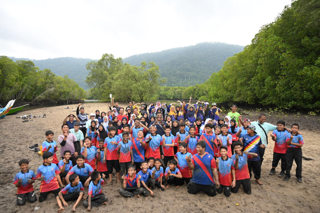 A group photograph of the adults and children who took part in the community initiative