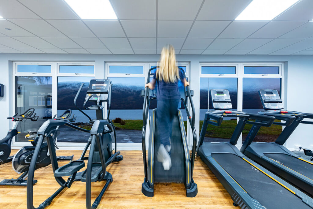 A female guest using the elevated treadmill in the Matrix Gym