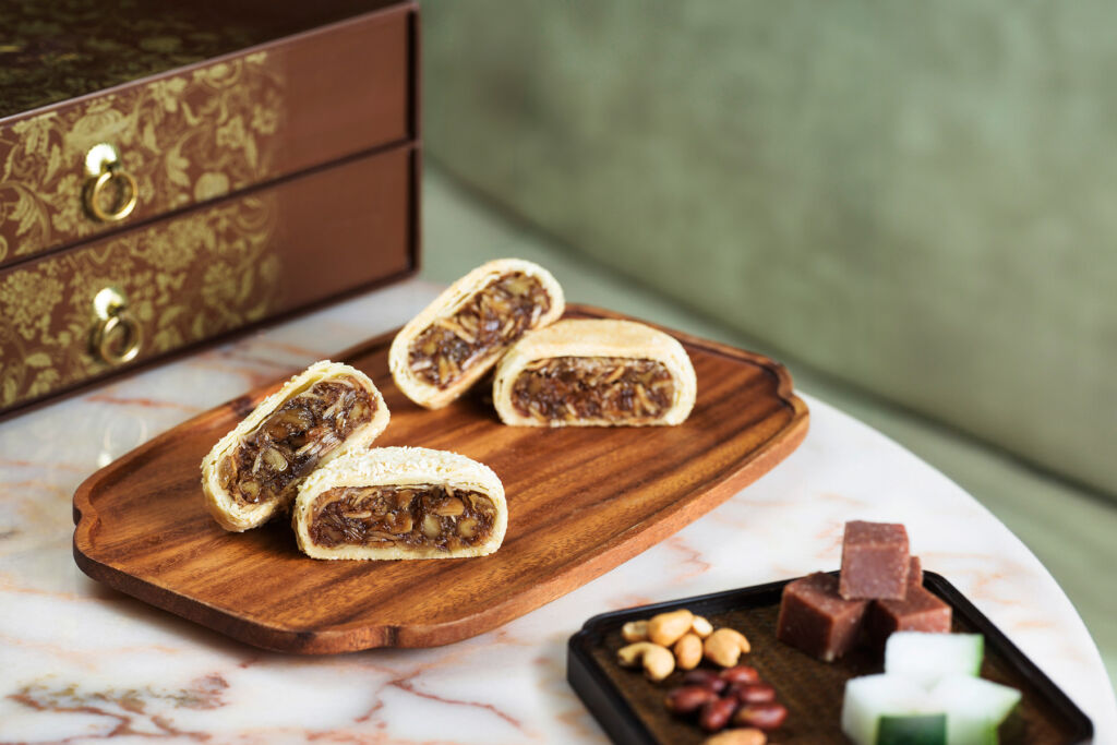 Sliced Fujian Mooncakes on a wooden cutting board