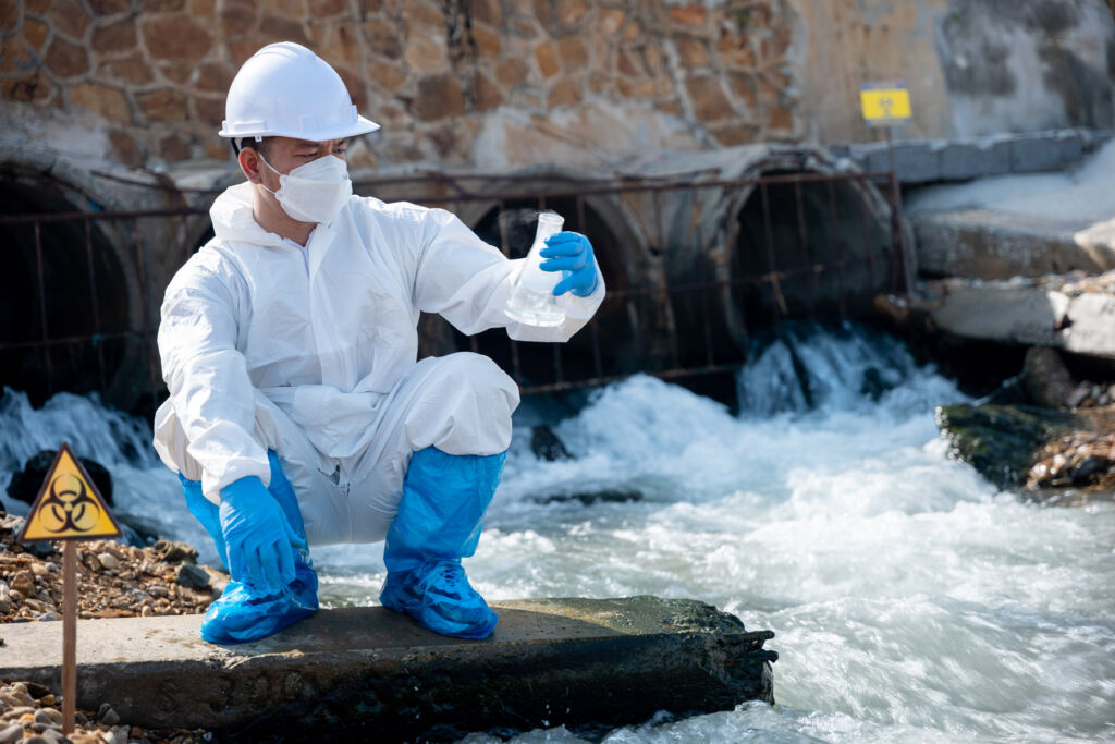 A researcher taking samples from a natural water source