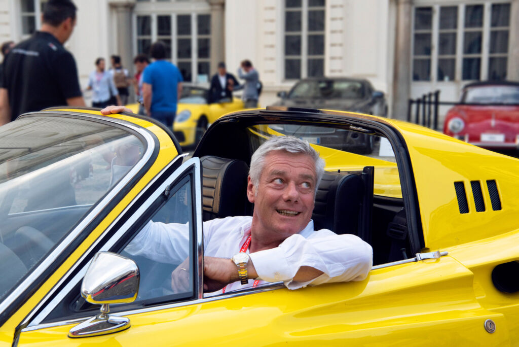 Paul driving a bright yellow sportscar