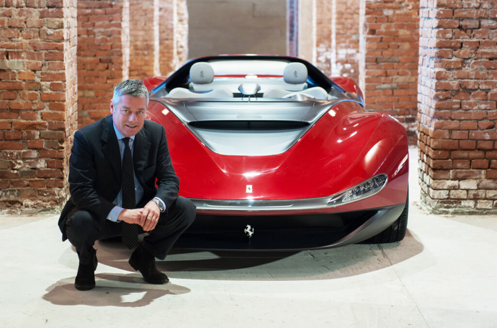 Paulo crouched in front of a unique sportscar