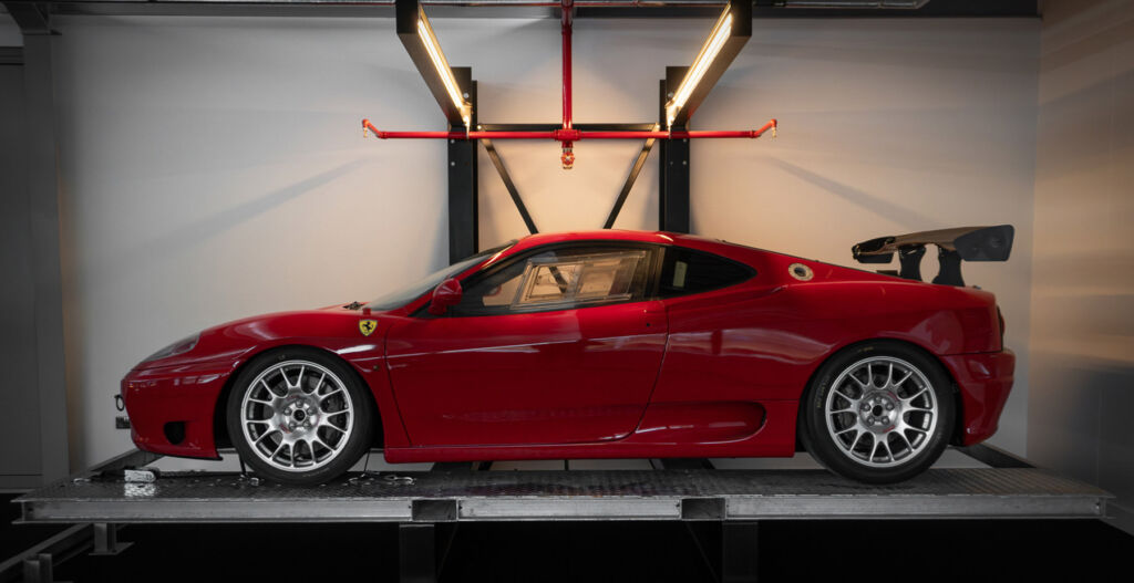 A photograph of a Ferrari on its dedicated bed