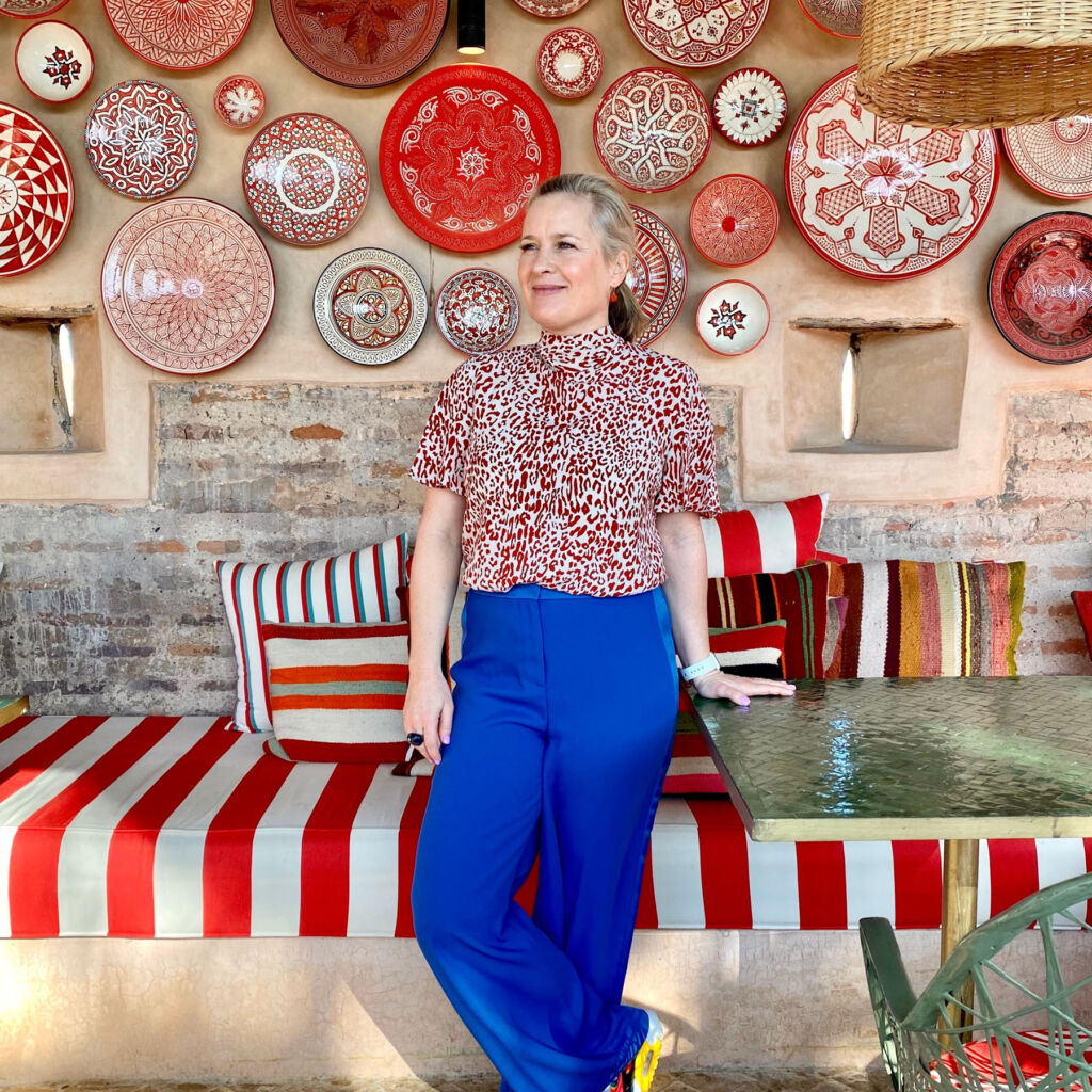 Sophie Robinson standing in front a wall of plates