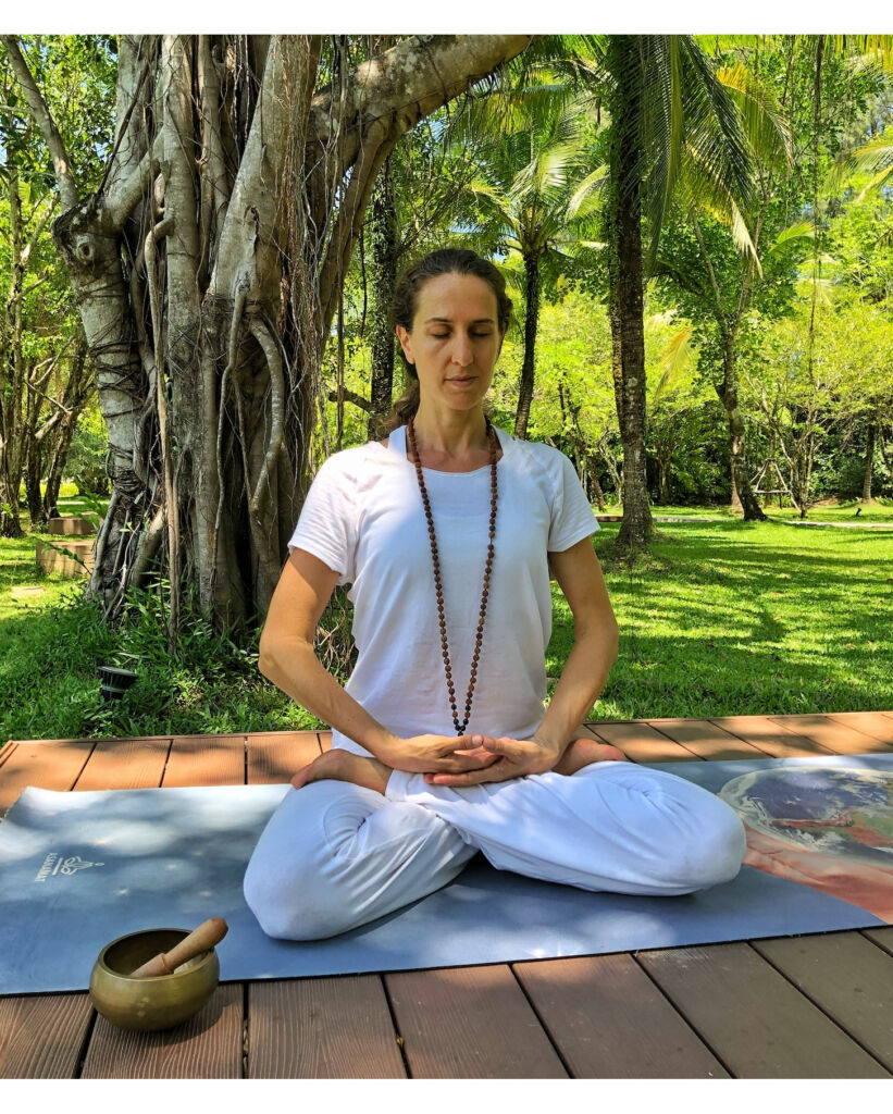 A female instructor in a Lotus pose