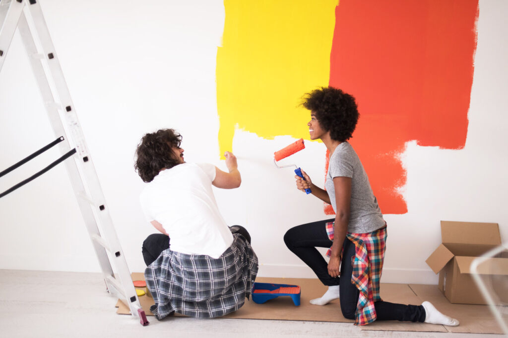 Young Couple Painting Walls in their Home