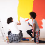 Young Couple Painting Walls in their Home