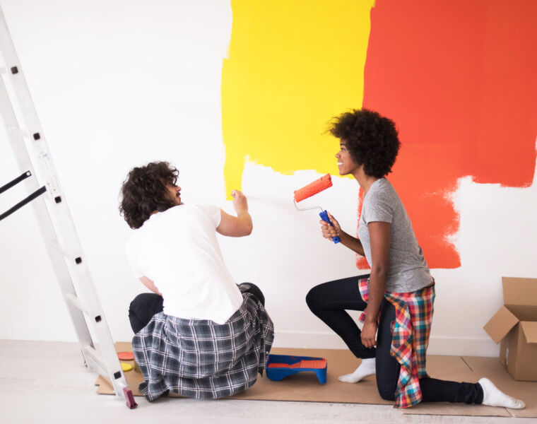 Young Couple Painting Walls in their Home