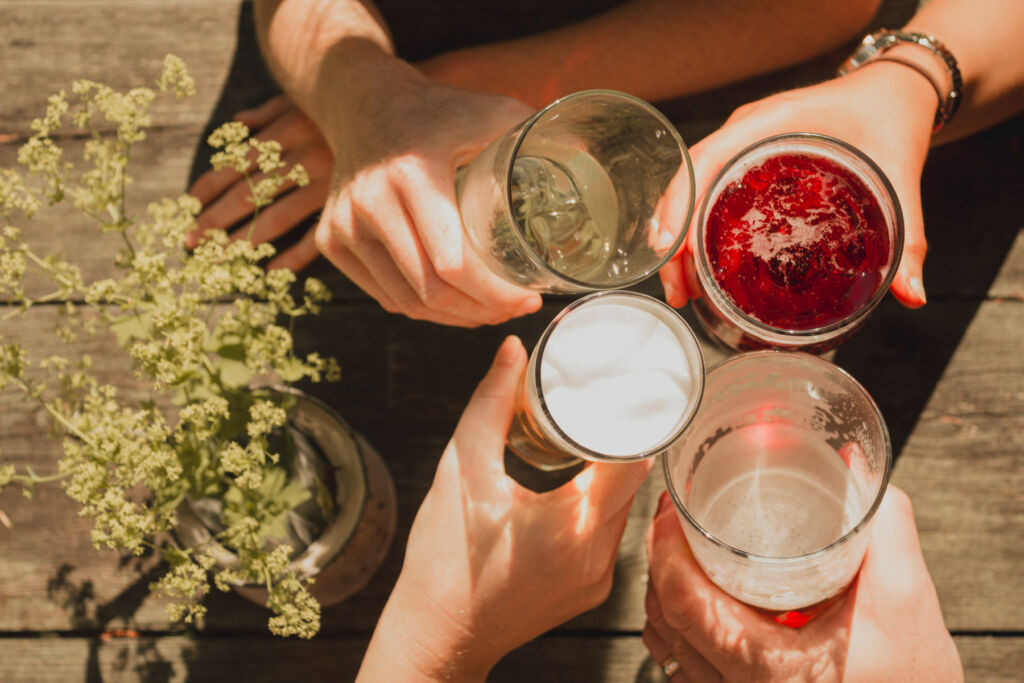 Friends making a toast outdoors in the sunshine