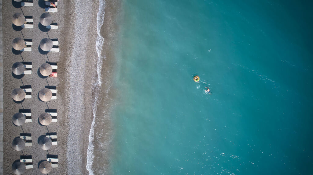 An aerial view of the beach and turquoise coloured sea