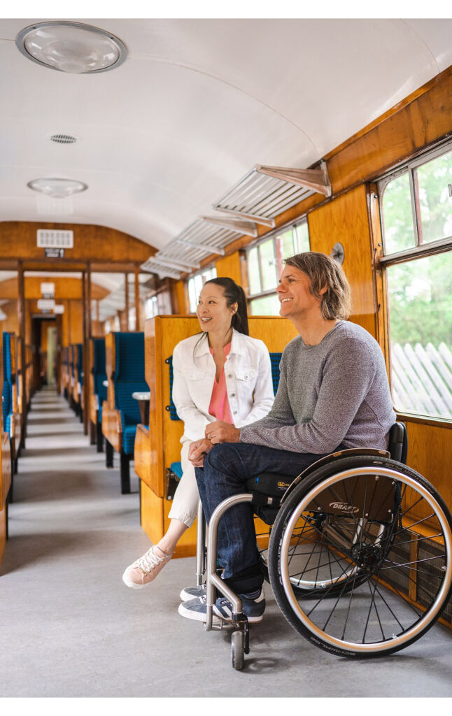 A man in a wheelchair enjoying his train journey