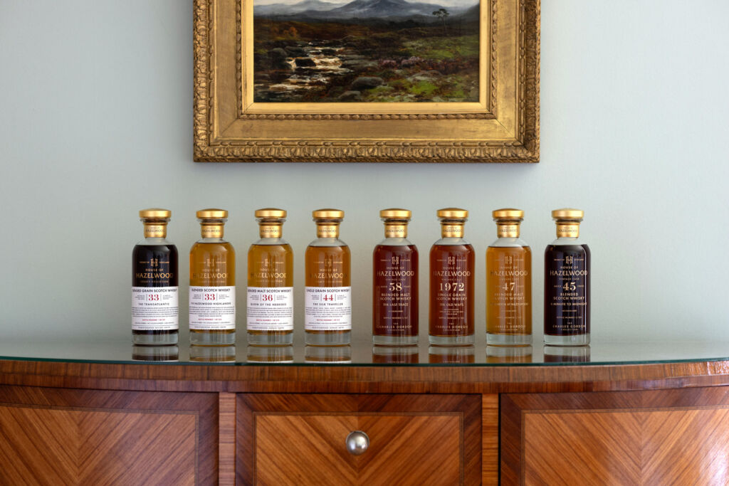 The bottles in the House of Hazelwood – The 2024 Collection placed next to each other on a wooden cabinet