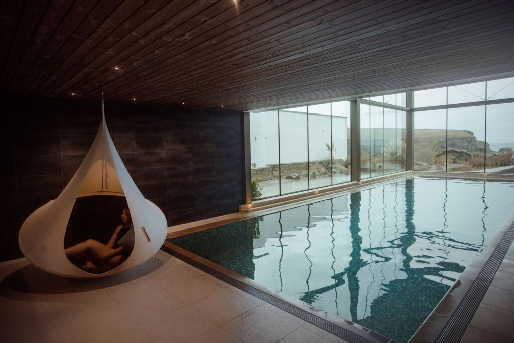 A woman relaxing in a hanging pod