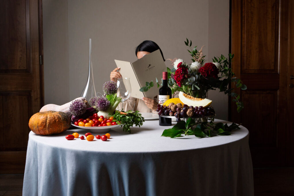 A guest at a table reading the La Rocca menu