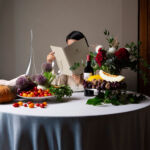 A guest at a table reading the La Rocca menu