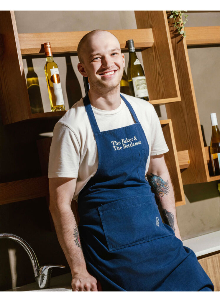 A smiling Jake leaning on the bar