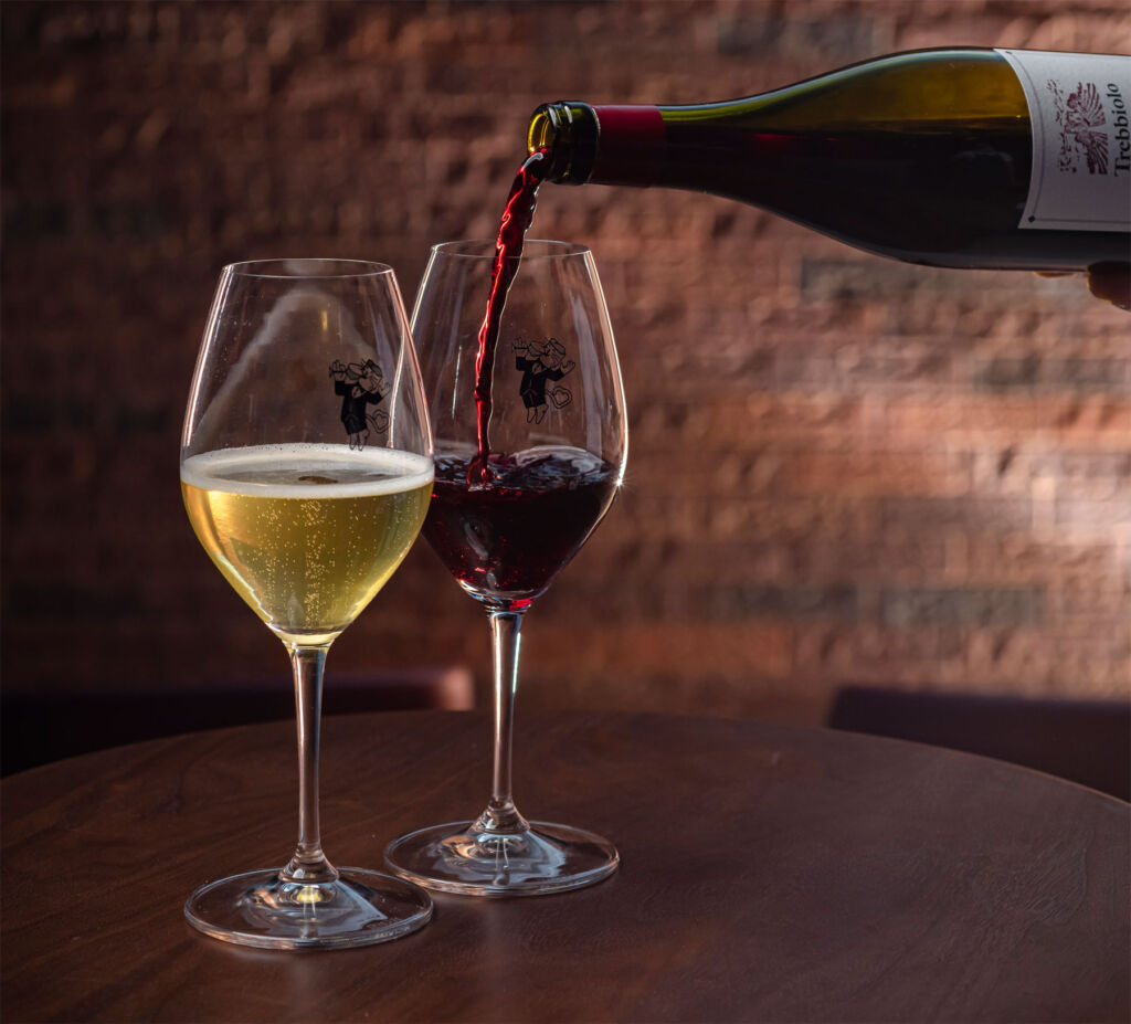 Wine glasses being filled at the table