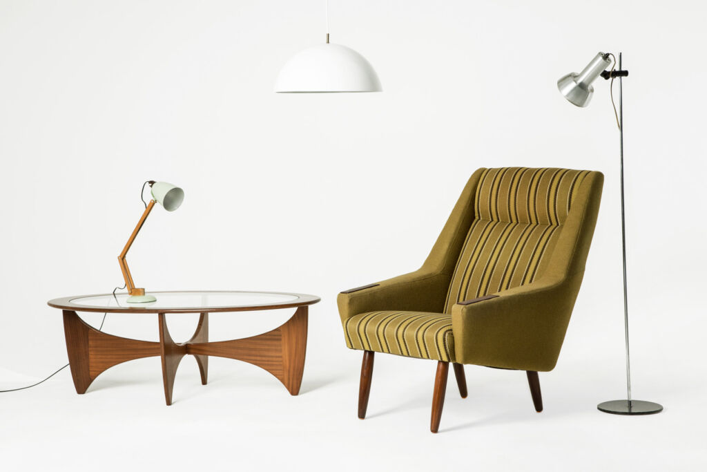 A wingback chair, glass topped table and vintage lighting from Bull and Tash