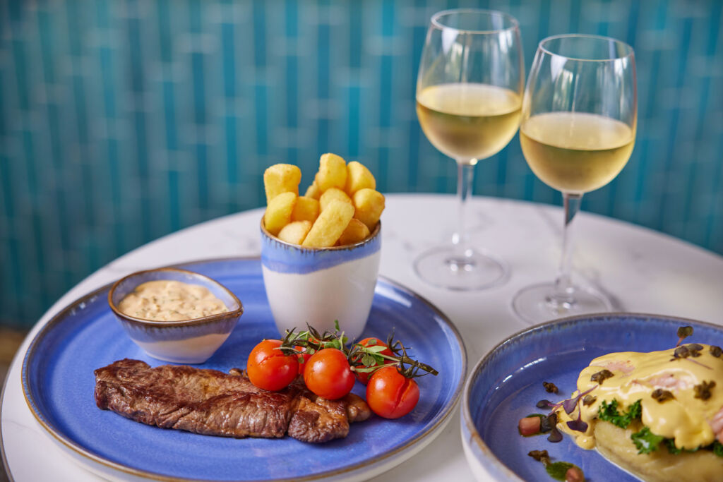 A photograph of a meat and vegetable dish with chips