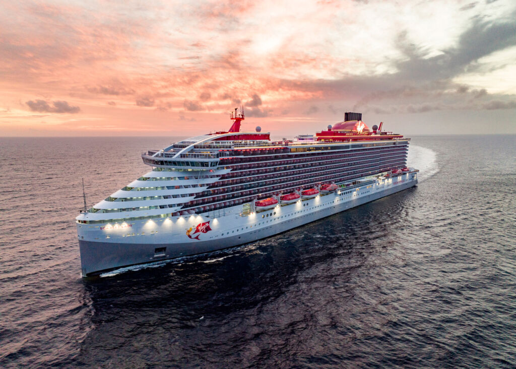 One of the Virgin cruise ships sailing on the sea at sunset