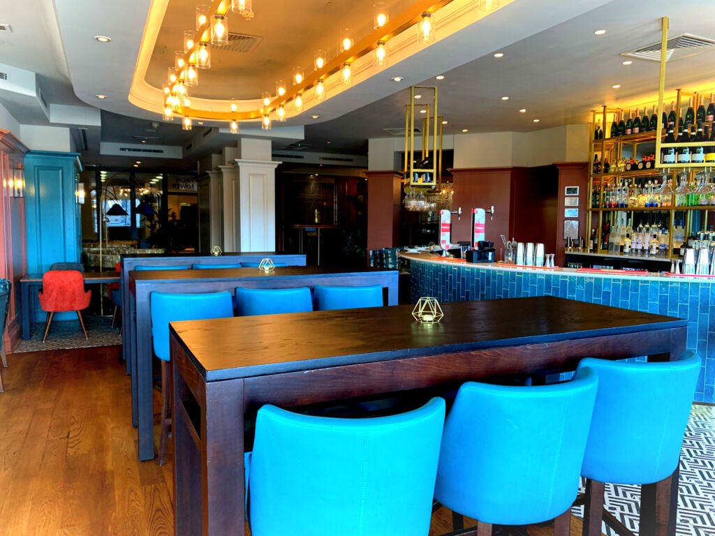 The bar area with its bright blue coloured curved chairs