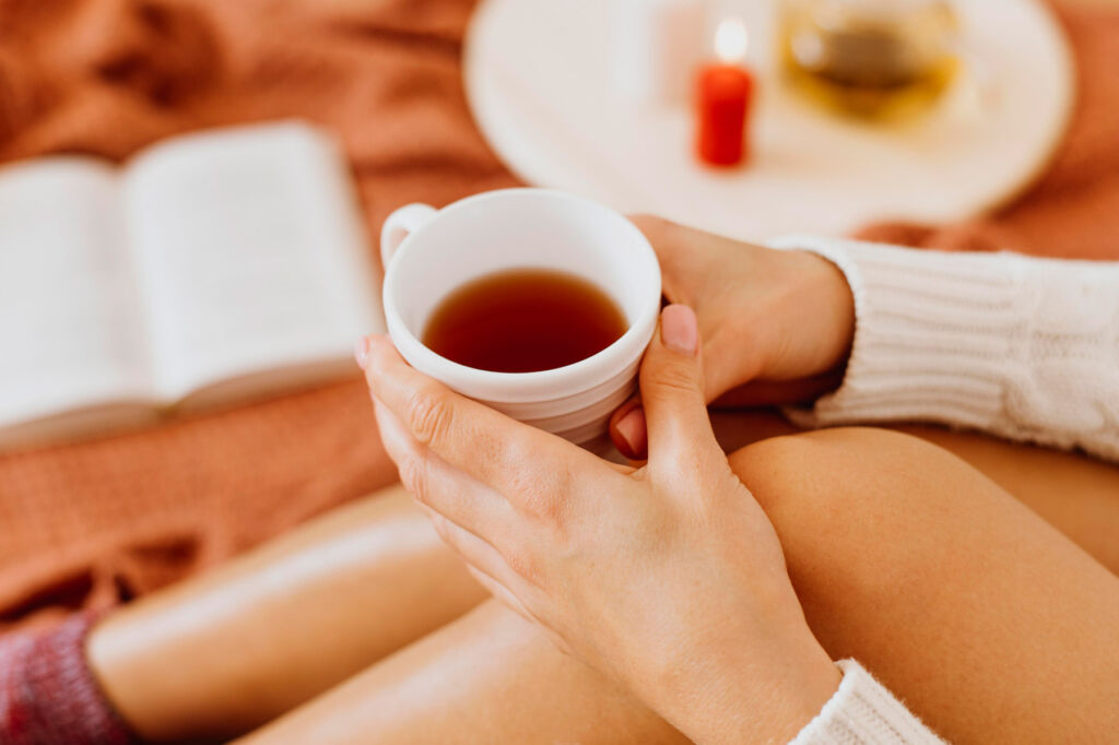 A young woman holding a cup of tea