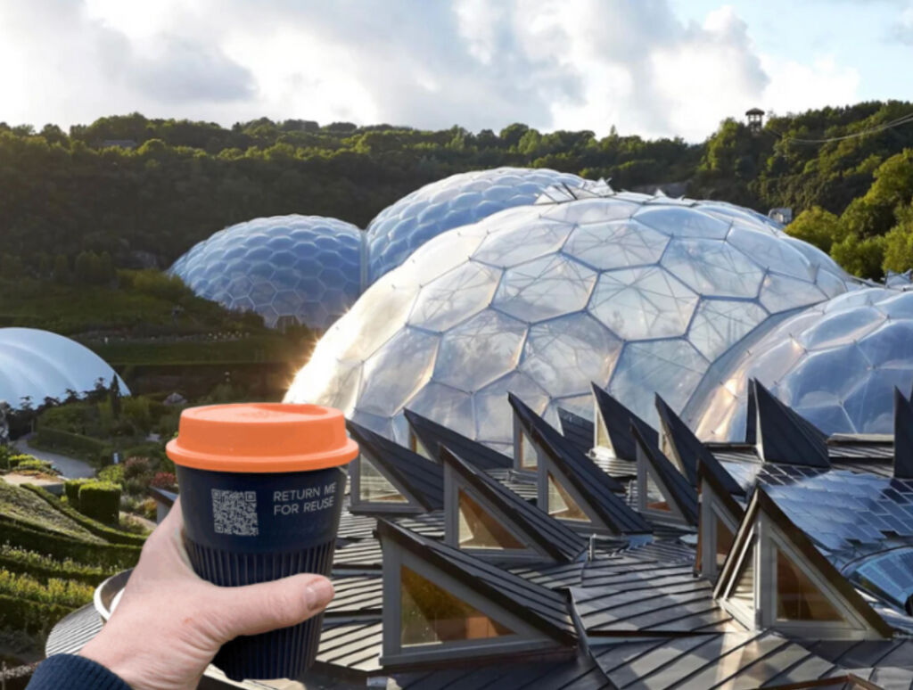 One of the single use cups being held above the iconic Eden Project