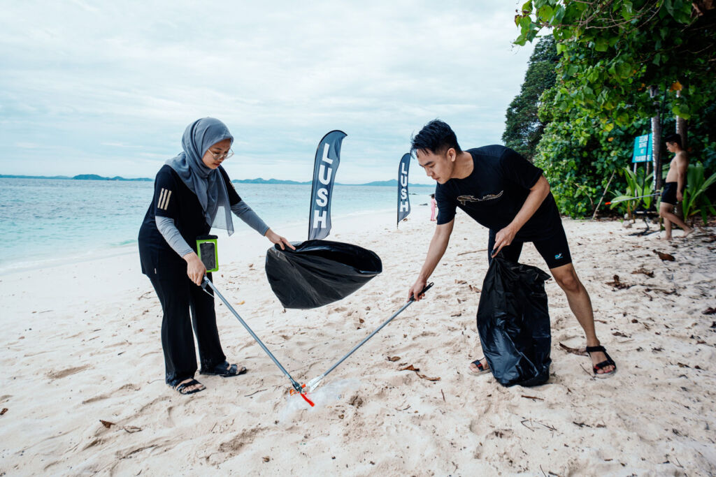 Two members of the team collecting plastic waste from the beach