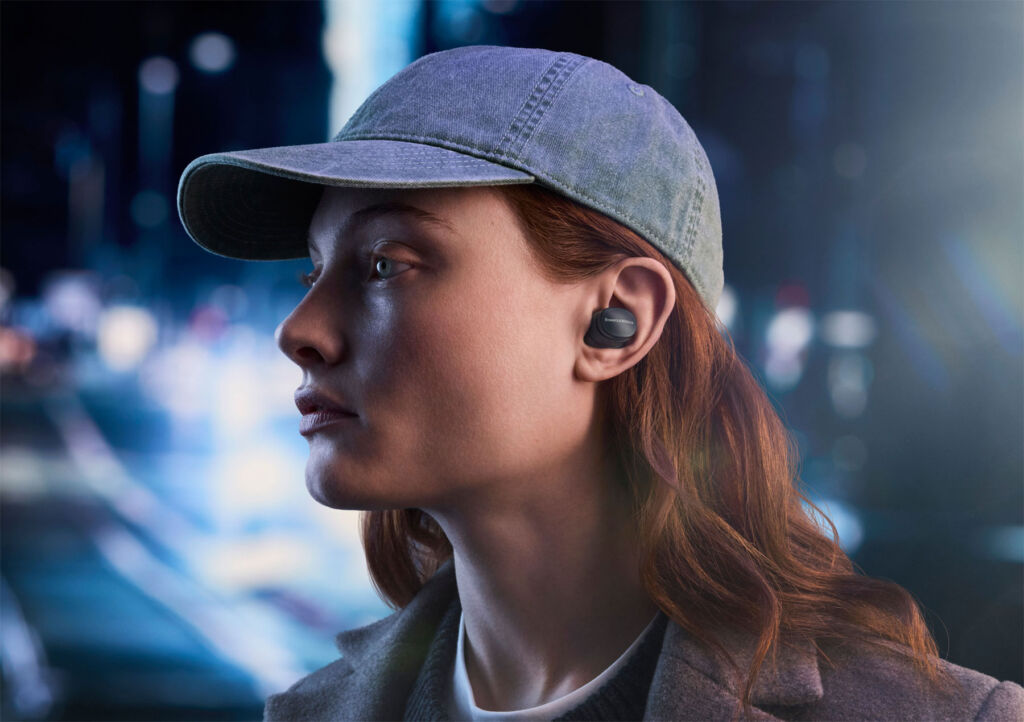 A woman wearing the new earbuds