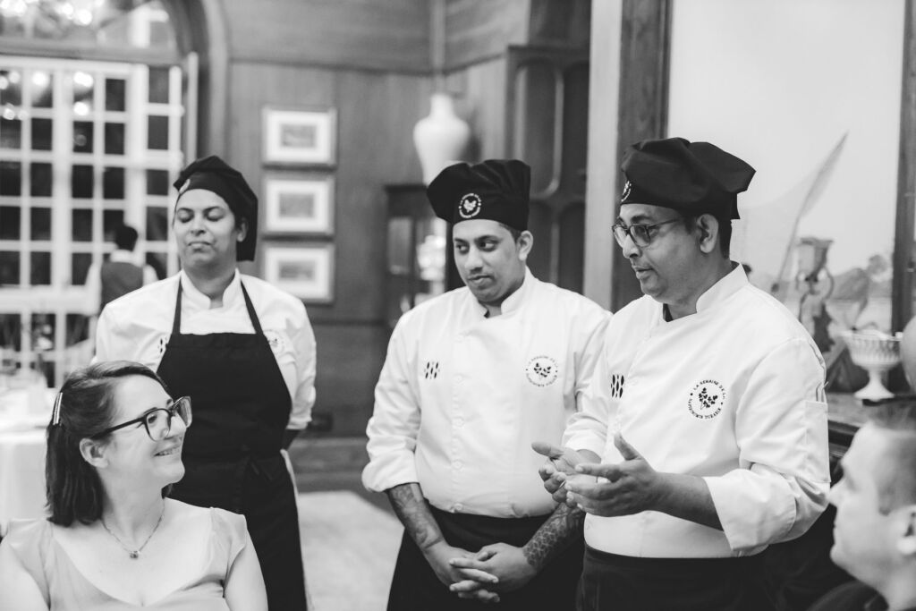 Chefs talking to a female guest