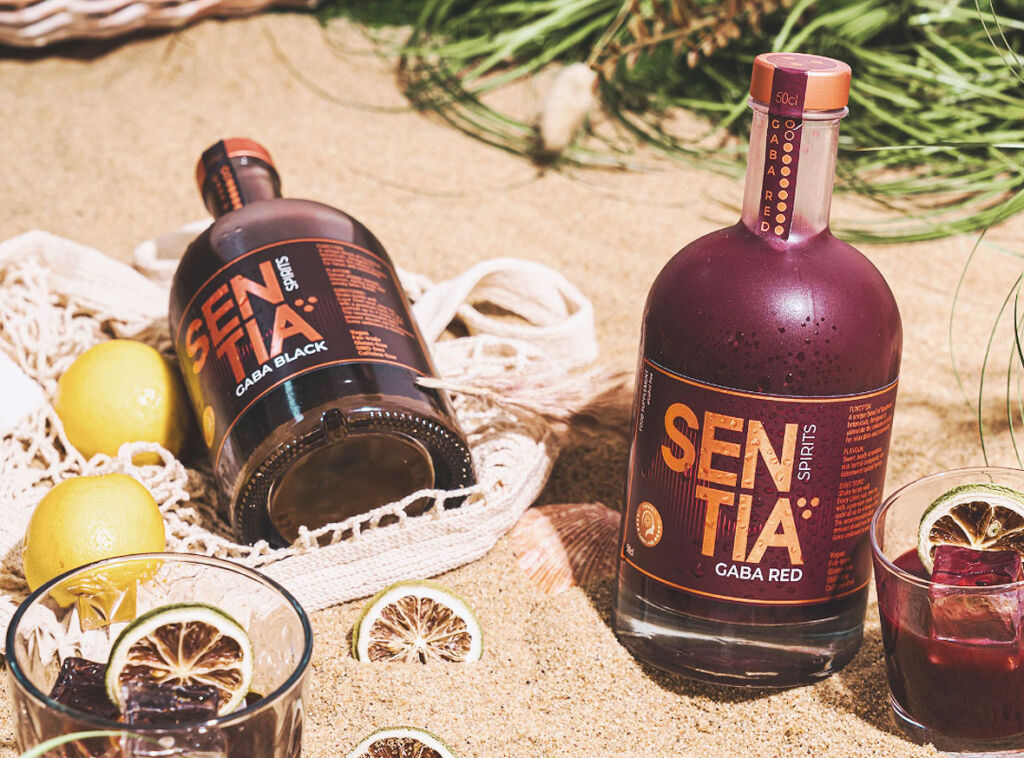 Bottles of the two flavours on a beach