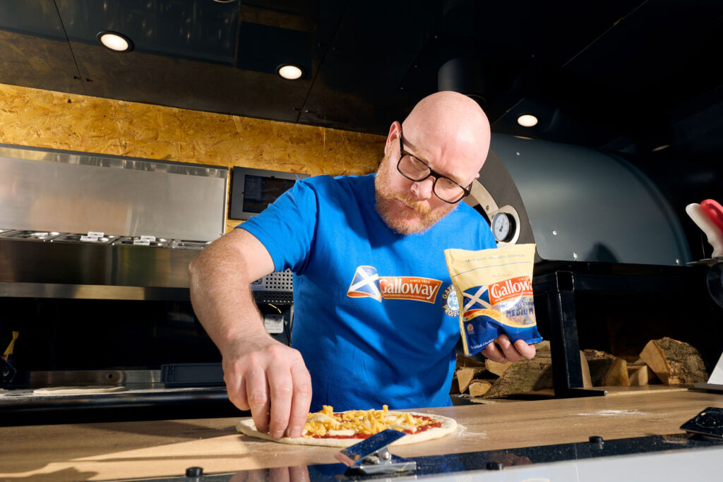 Gary preparing a pizza in the food truck