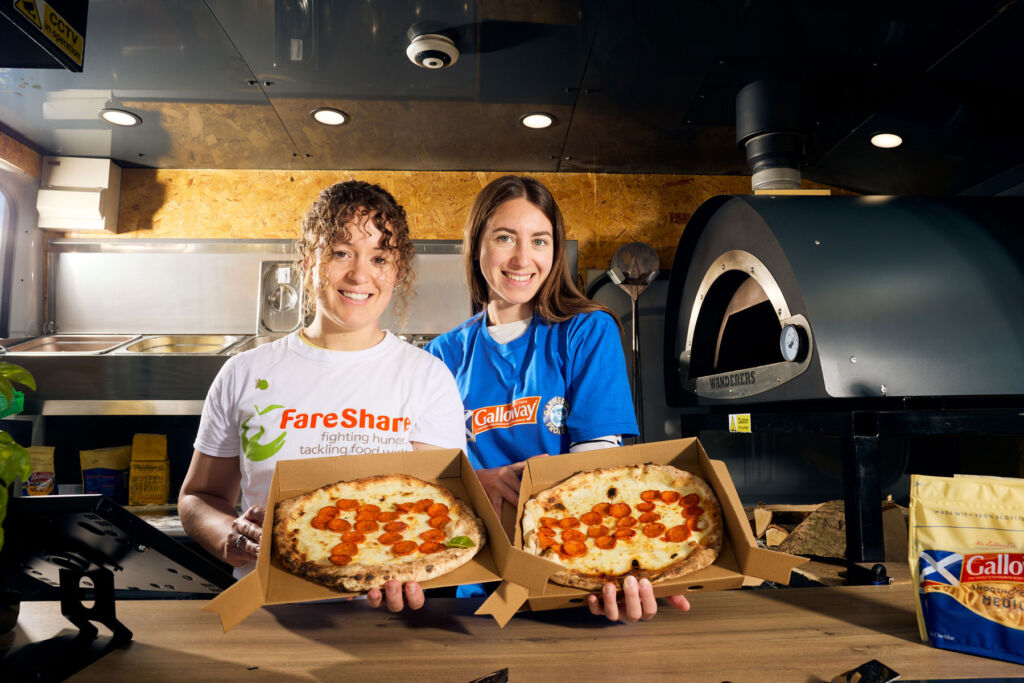 Heloise and Kirsty showing off one of the freshly made pizzas