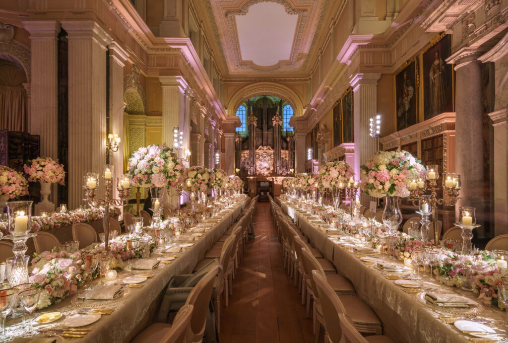 A long line of tables in one of the large historical rooms