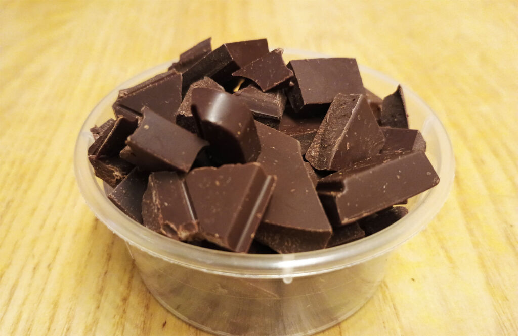 Chunks of chocolate on a plastic tub