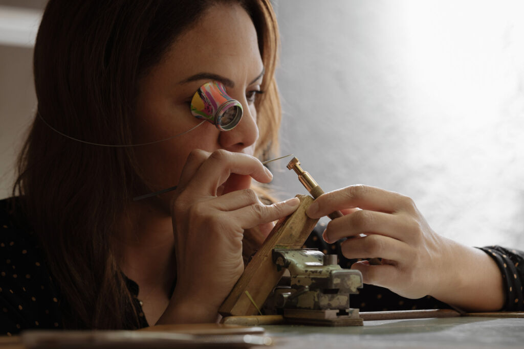 A member of the watchmaking team assembling one of the timepieces