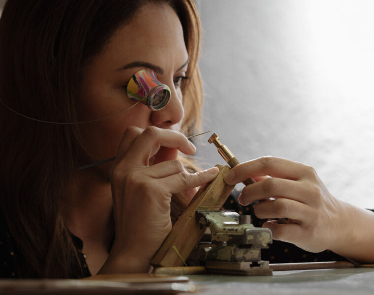 A member of the watchmaking team assembling one of the timepieces