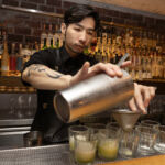 A bartender making a cocktail at COA