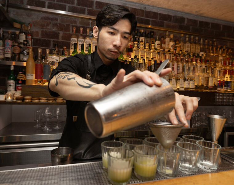 A bartender making a cocktail at COA