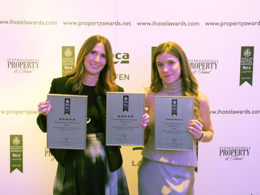 Two ladies holding the awards