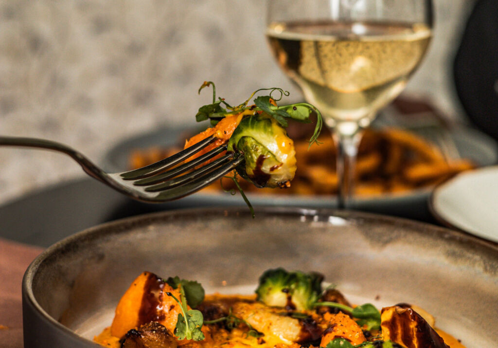 A guest enjoying a vegetable dish