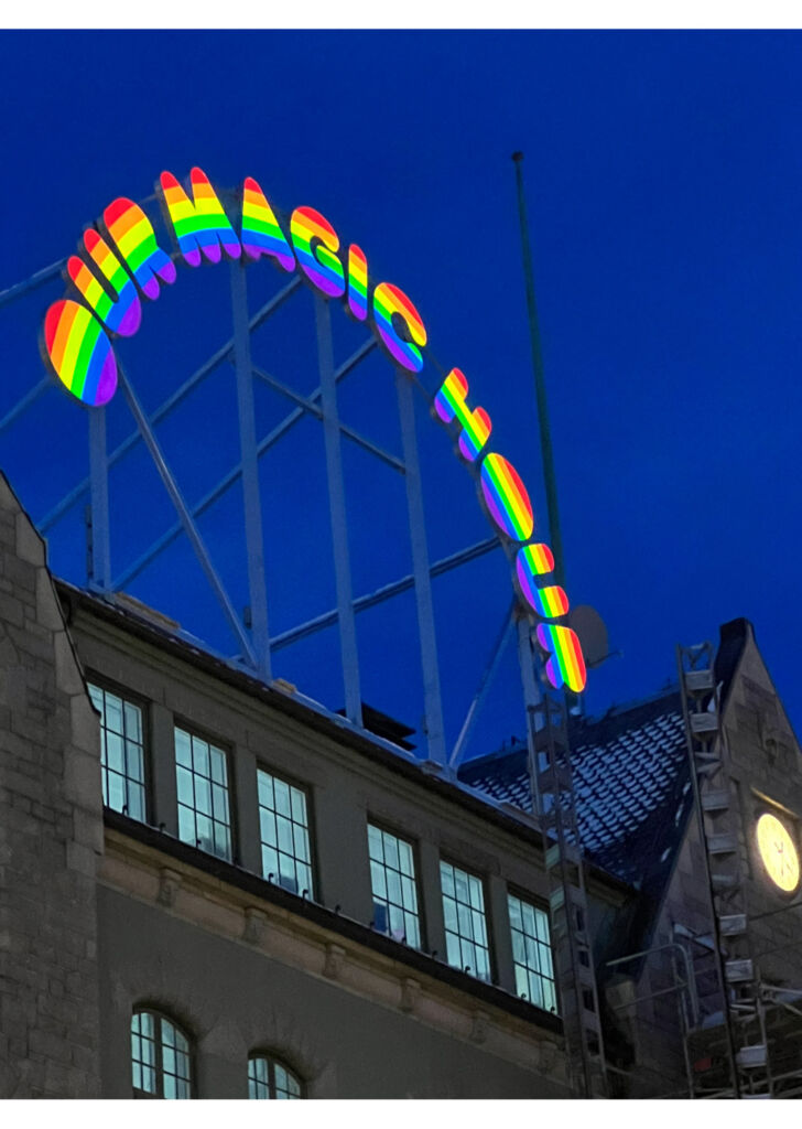 The arched rainbow coloured signage above the museum with the words Our Magic Hour