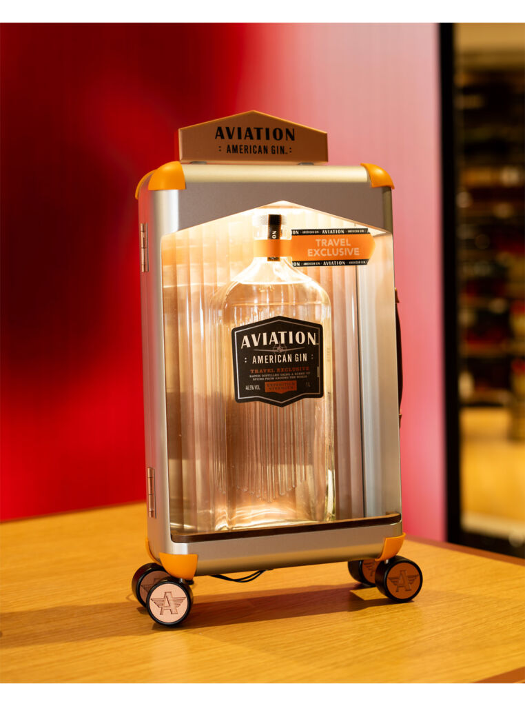 A bottle of the gin inside a case in the shape of a suitcase