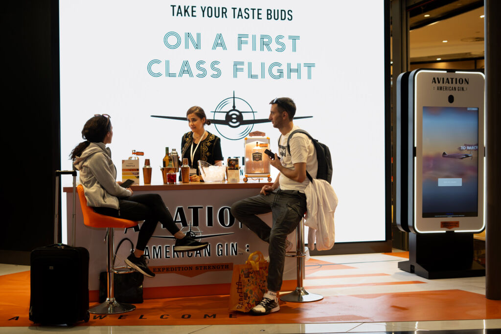 A couple enjoying a drink at the airport pop-up